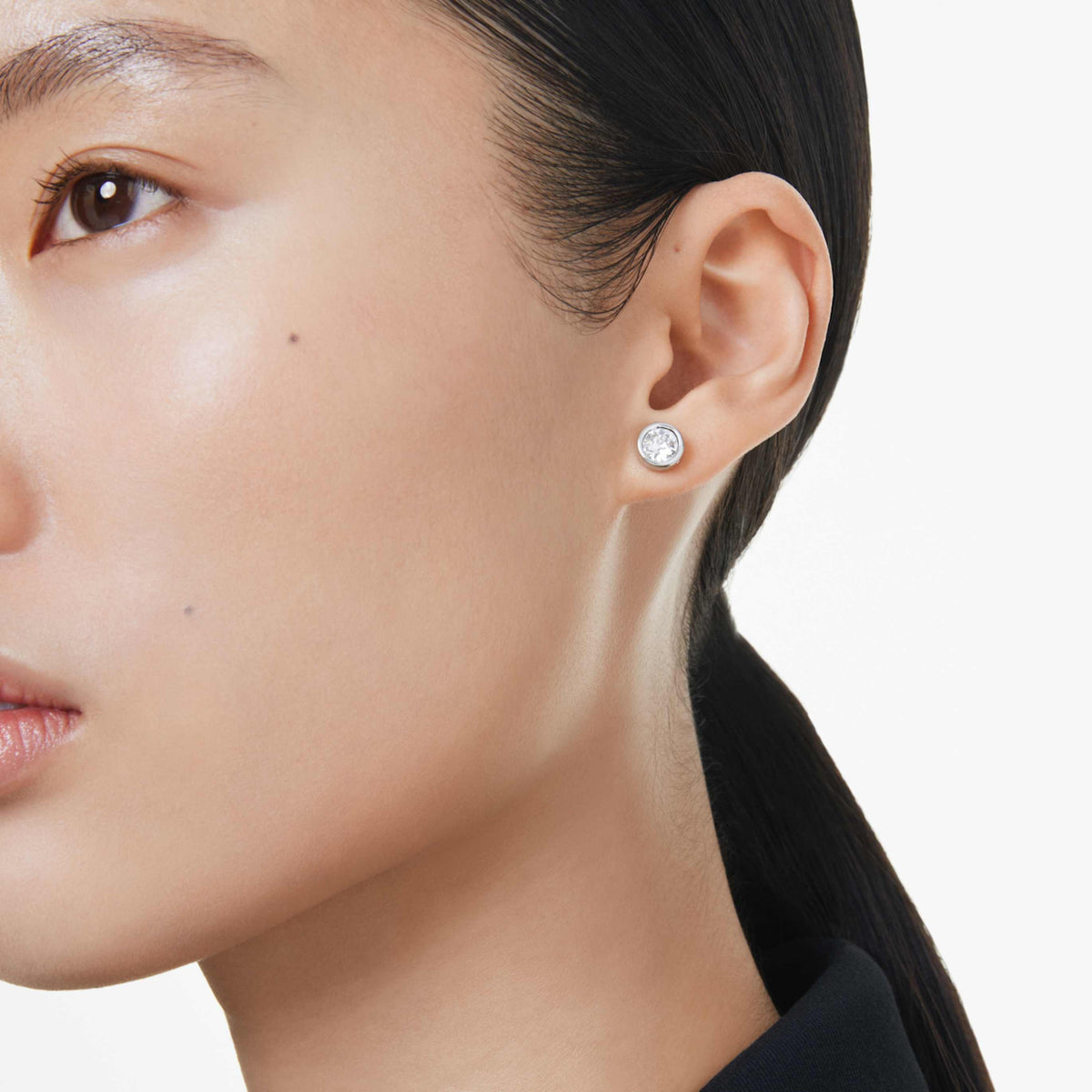 Swarovski Imber stud earrings with white round-cut accents and an 18K gold finish