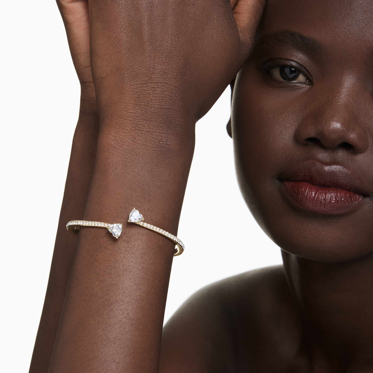 Swarovski Mesmera bangle featuring a heart motif with white accents and rhodium plating