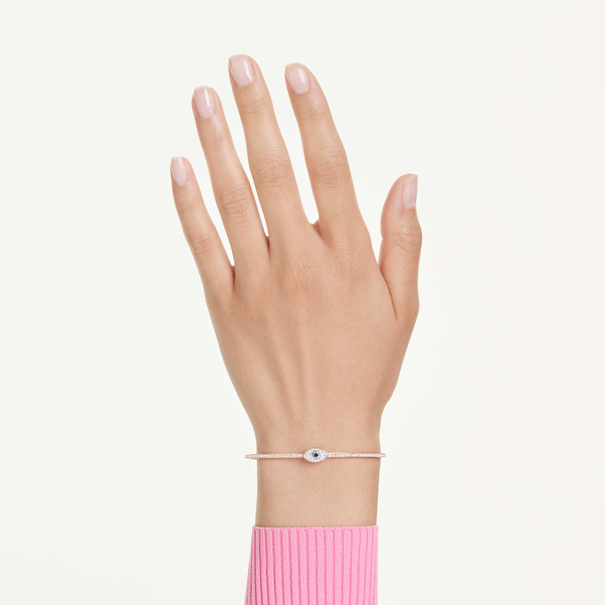 Swarovski Symbolica bangle featuring a evil eye motif with blue accents and an 18K gold finish