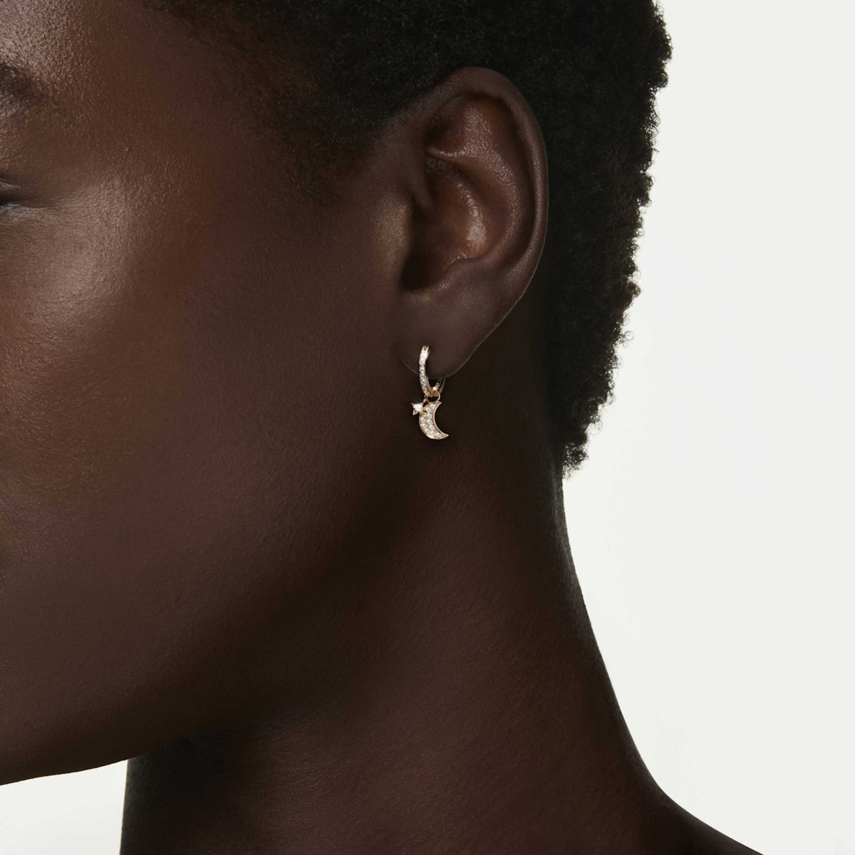 Swarovski Symbolica drop earrings featuring a moon motif with blue round-cut accents and rhodium plating