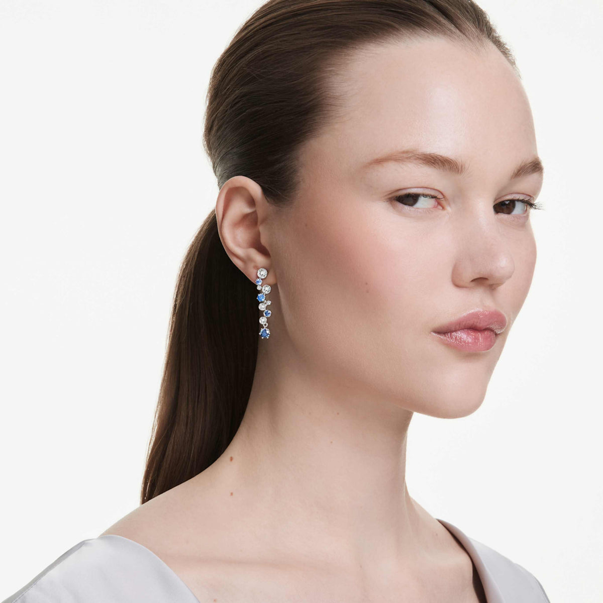 Swarovski Constella drop earrings with green mixed-cut accents and an 18K gold finish