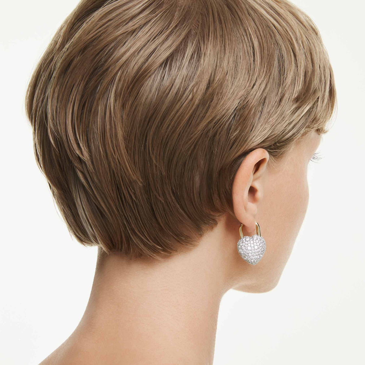 Swarovski Idyllia drop earrings featuring a heart motif with white mixed-cut accents and an 18K gold finish