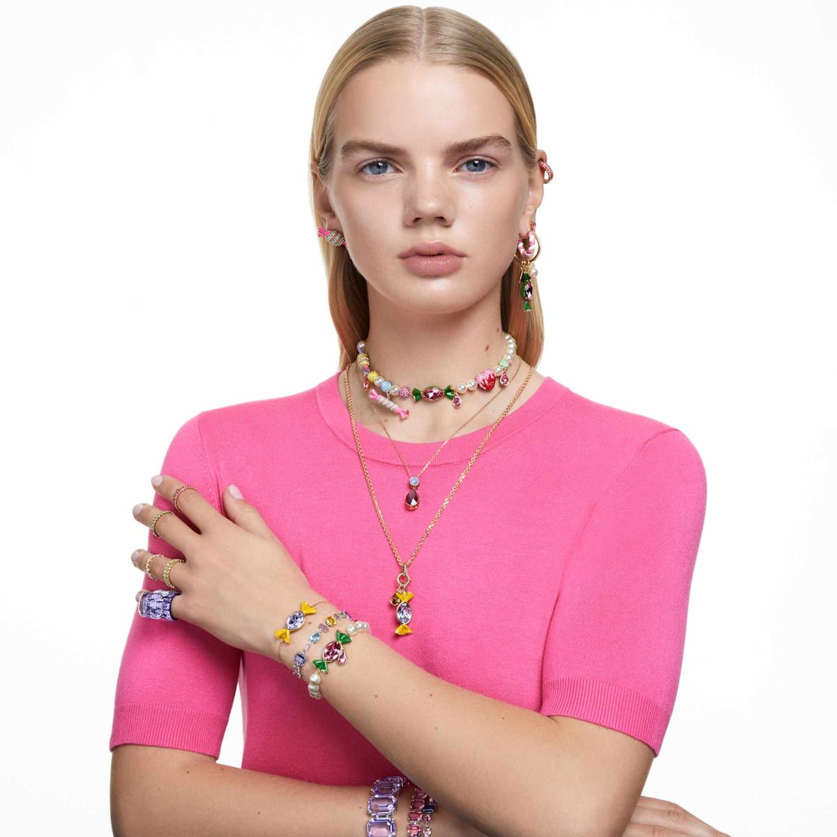Swarovski Matrix hoop earrings with pink baguette-cut accents and an 18K rose gold finish