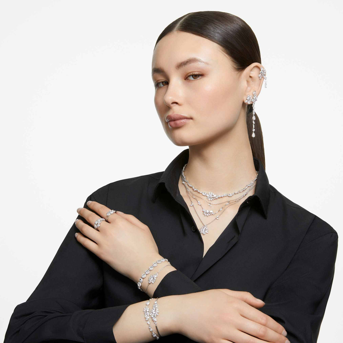 Swarovski Mesmera stud earrings featuring a flower motif with white mixed-cut accents and rhodium plating