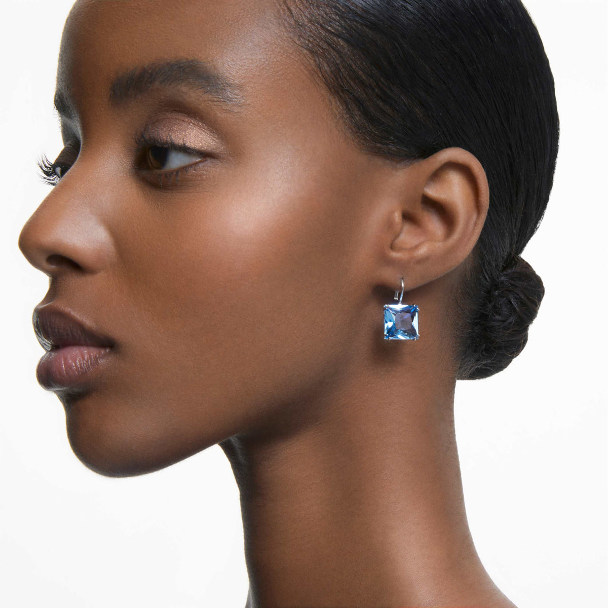 Swarovski Millenia drop earrings with green square-cut accents and an 18K gold finish