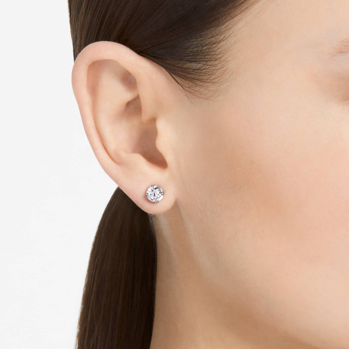 Swarovski Stilla stud earrings with white round-cut accents and an 18K gold finish