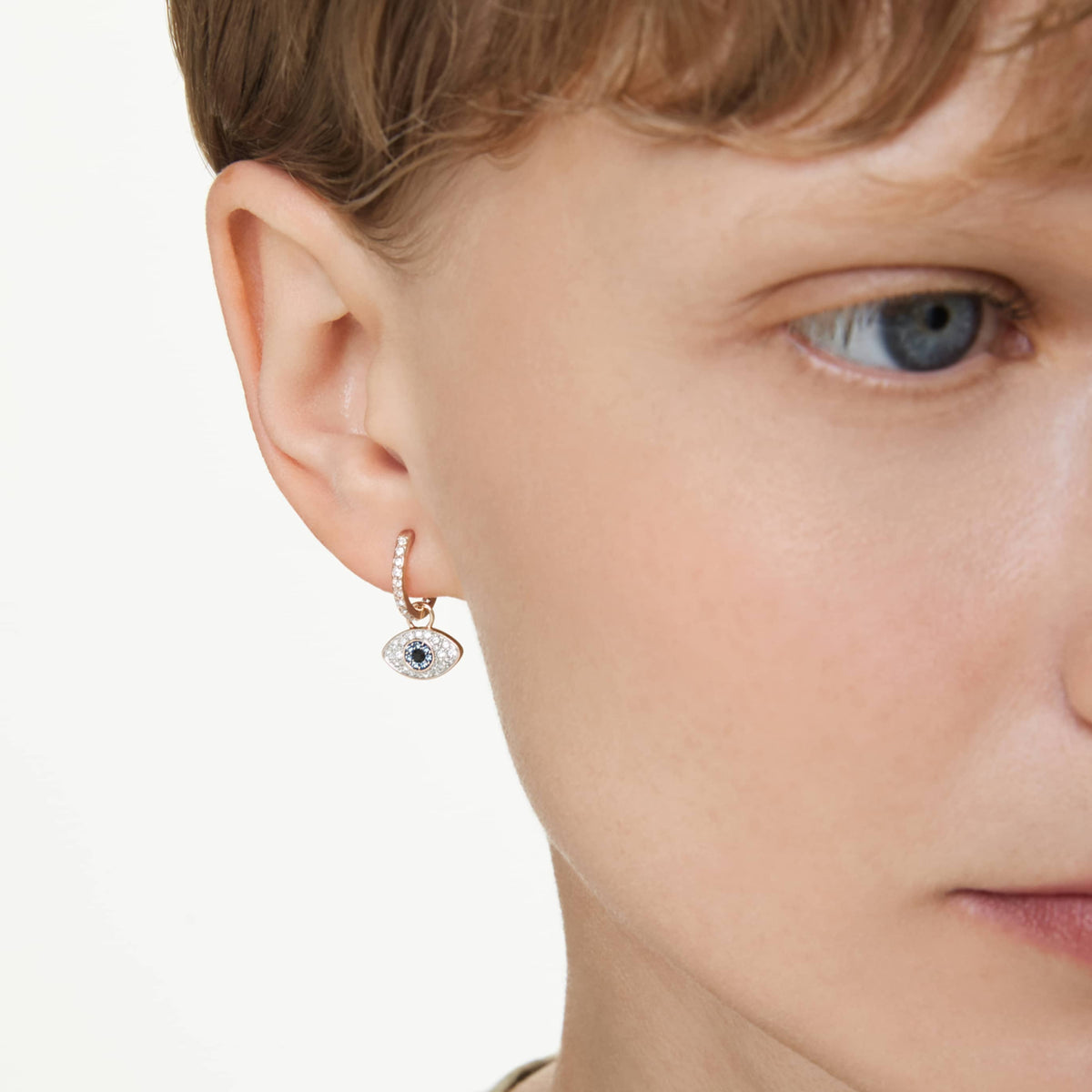 Swarovski Symbolica drop earrings featuring a evil eye motif with blue accents and an 18K gold finish