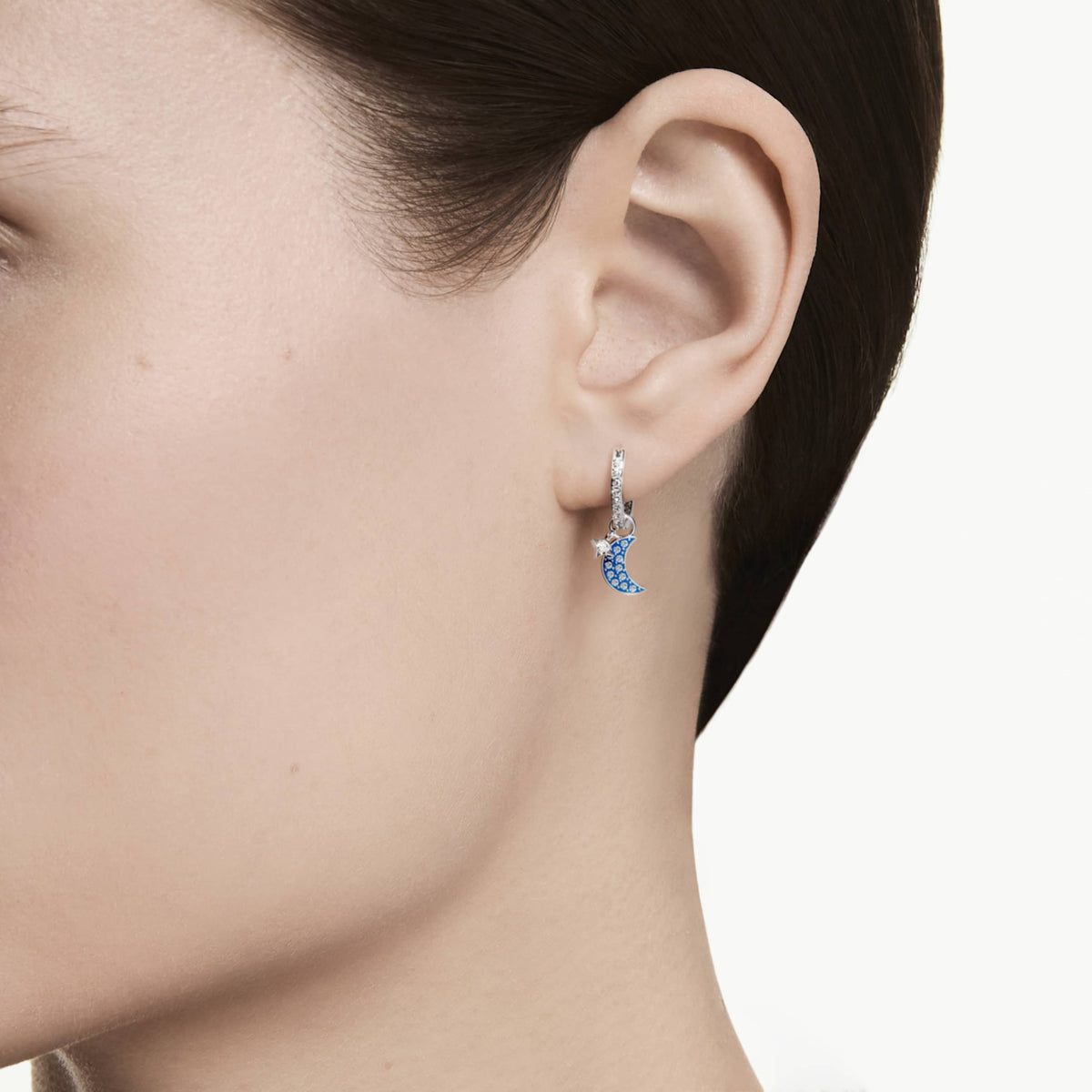 Swarovski Symbolica drop earrings featuring a moon motif with white round-cut accents and an 18K gold finish