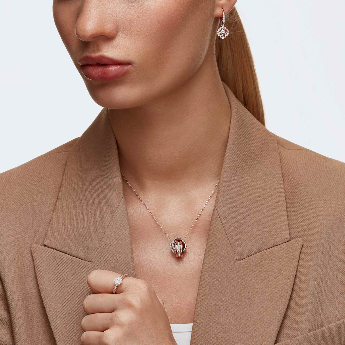 Swarovski Una drop earrings featuring a clover motif with pink accents and an 18K rose gold finish